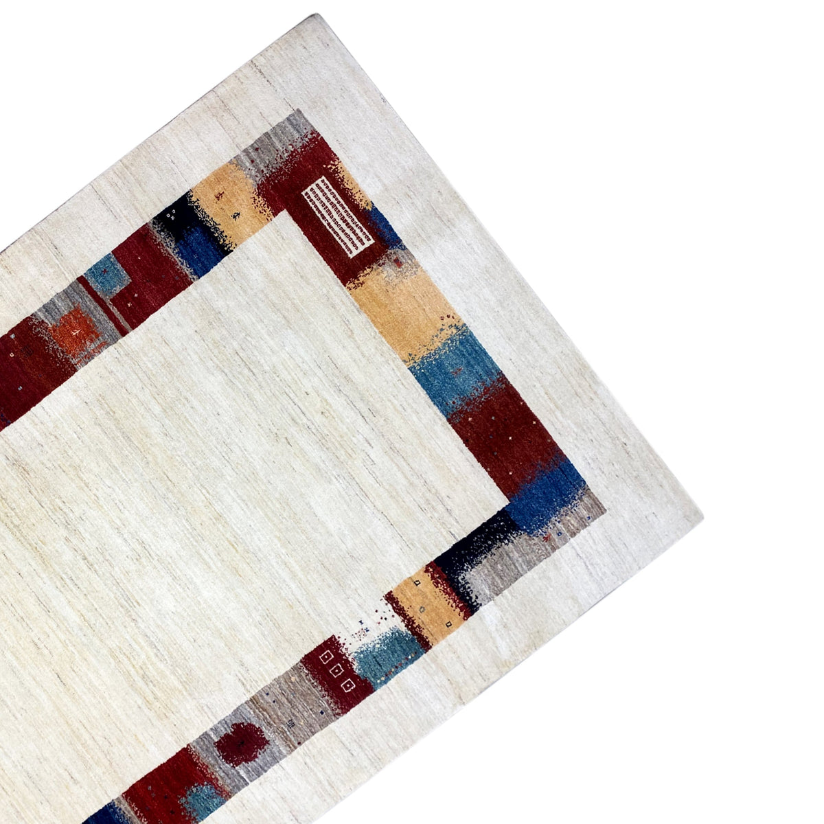 Hand-knotted Gabbeh rug detail: cream-colored pile with a colorful decorative border stripe