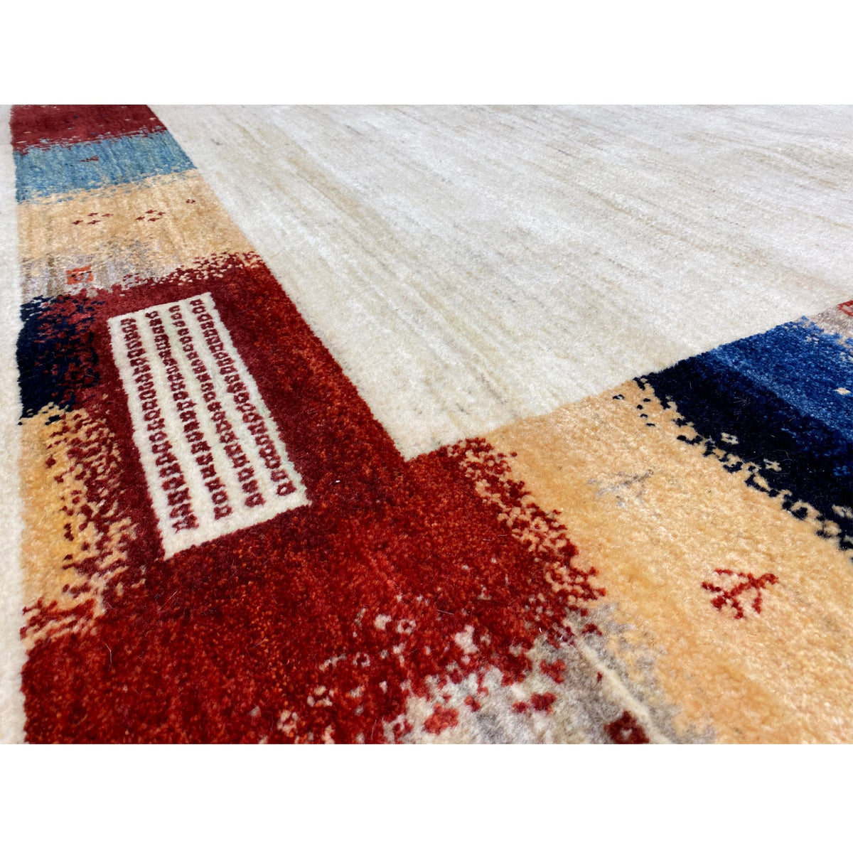 Close-up of a hand-knotted Gabbeh rug: Multicolored patterned tiles in a frame