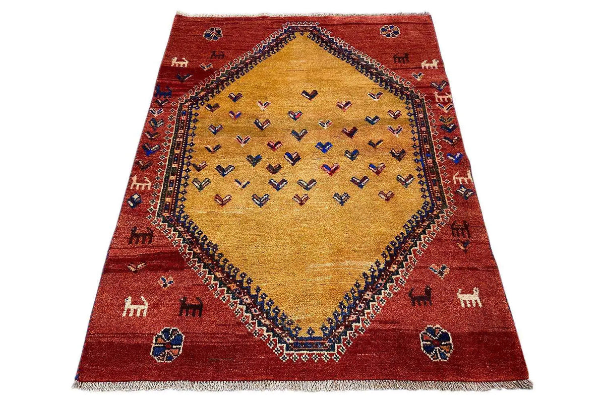 Gabbeh rug with a red border and beige central medallion, geometric pattern