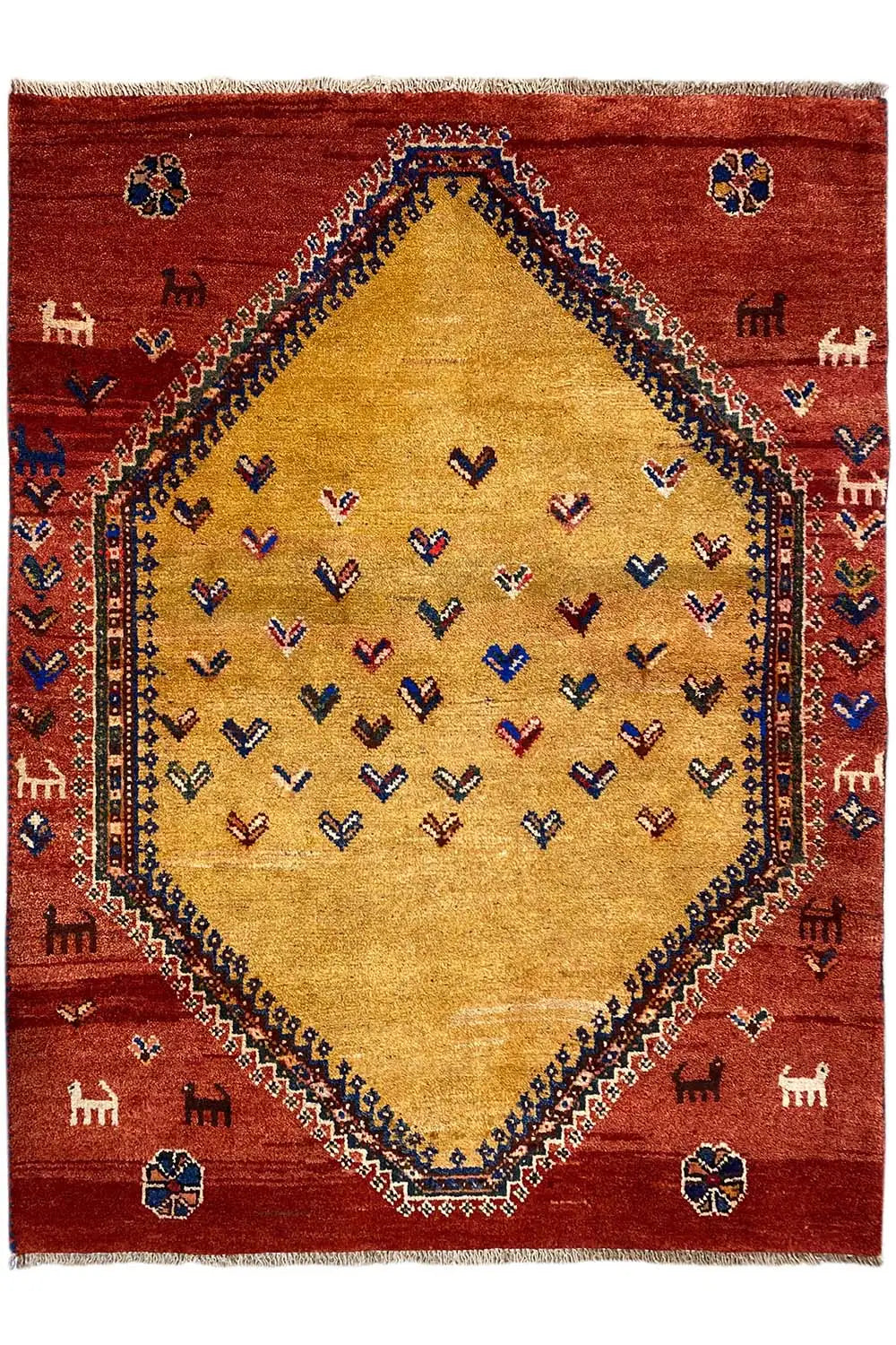 Gabbeh rug front view: red background, beige central medallion, and small animal motifs