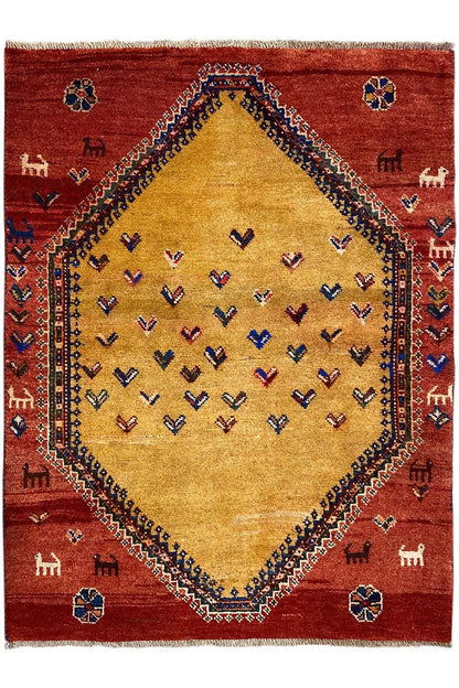 Gabbeh rug front view: red background, beige central medallion, and small animal motifs