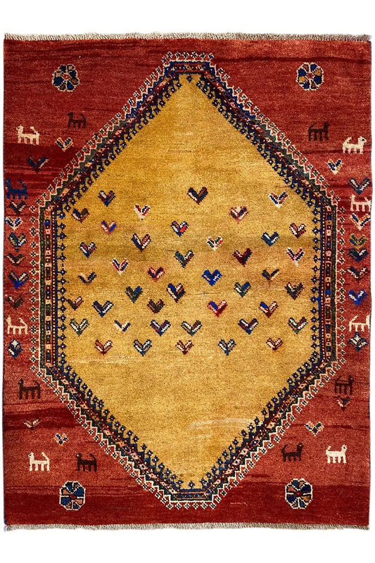 Gabbeh rug front view: red background, beige central medallion, and small animal motifs