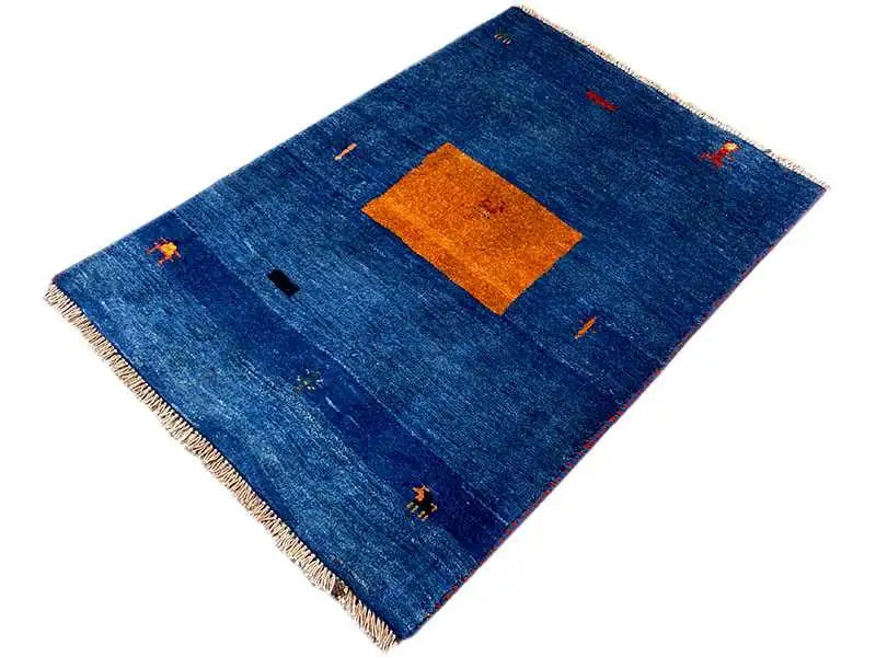Blue Gabbeh rug from a perspective view, orange rectangle, small colorful symbols, fringe