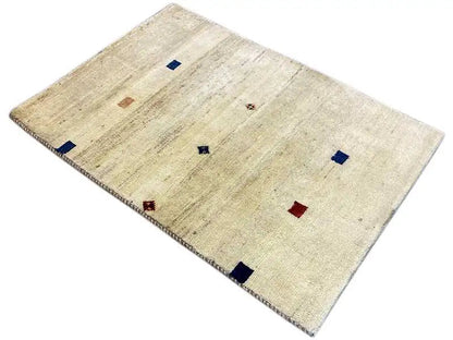 Gabbeh rug 119x84 cm, light beige, laid at an angle with blue and red pattern elements