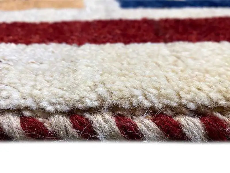 Close-up of a Gabbeh rug: pile and bound edge with short fringes