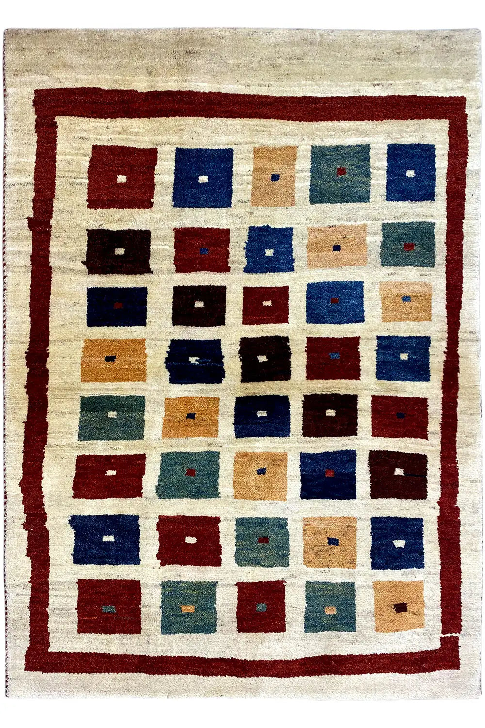Gabbeh rug with tile patchwork in blue, red, and beige; rectangular border