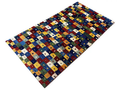 Gabbeh rug 150x79 cm, geometric block pattern with a blue background and multicolored quadrilaterals.