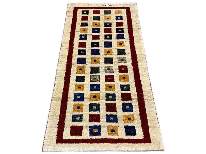 Gabbeh rug with a rectangular pattern and red borders in cream, blue, and yellow