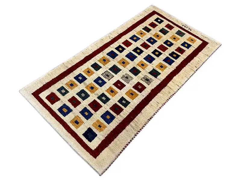 Gabbeh rug with a central square pattern, red border, and multicolored squares