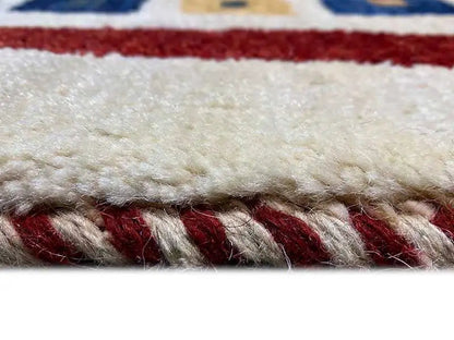 Gabbeh rug detail: pile and crimped fringe with red inner border