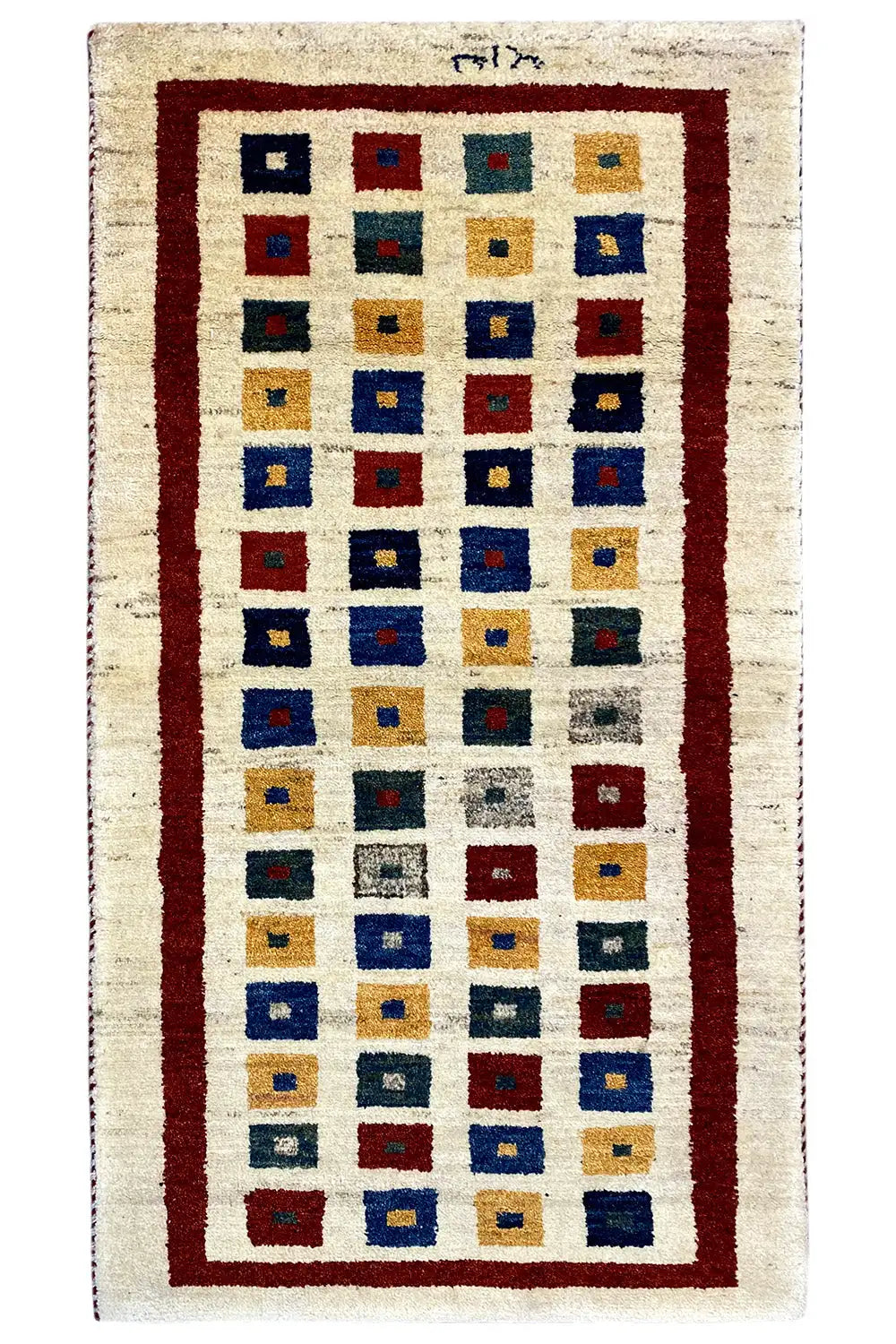 Gabbeh rug, photographed upright: rectangular diamond pattern with a red border and blue