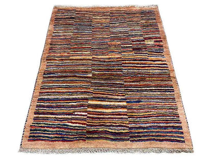 Rectangular rug with a multicolored striped pattern and fringes