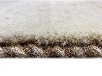 Close-up of a Gabbeh rug: pile with matted edges/fringes, light beige-brown