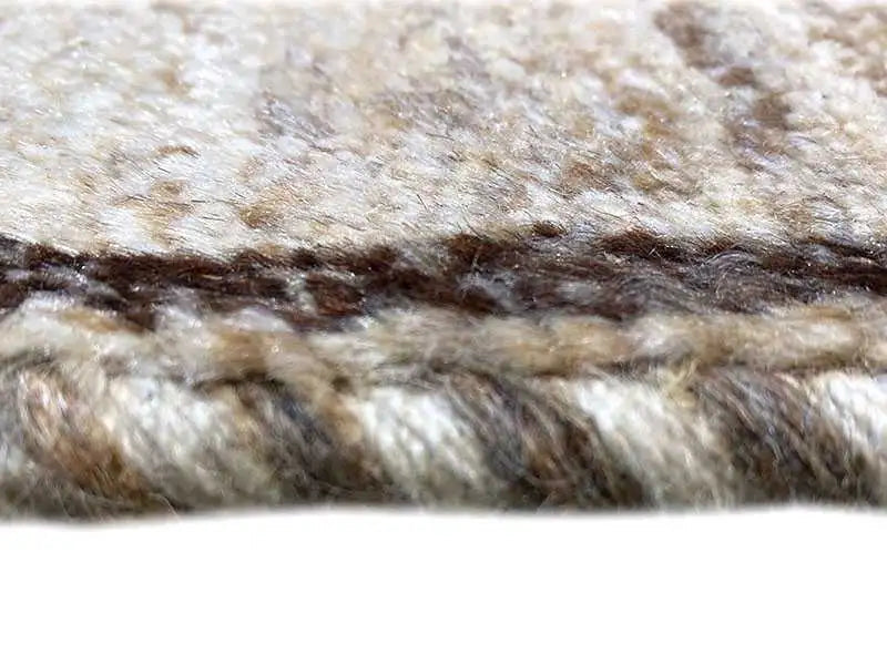 Gabbeh rug close-up: mottled pile, beige background with dark stripes