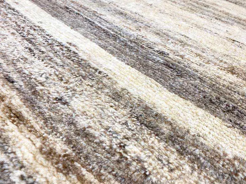 Gabbeh rug surface: beige and gray striped pattern, dense pile
