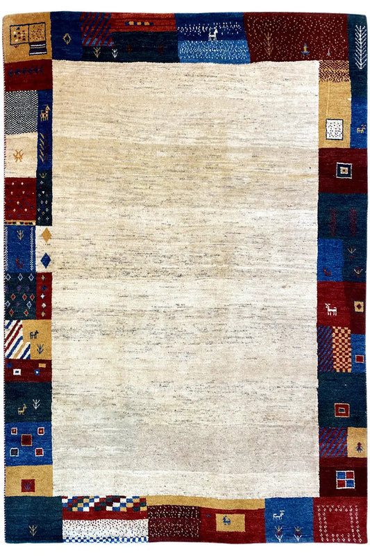 Gabbeh rug all around: beige center, dark blue border with multicolored patch motifs