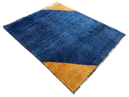 Blue rectangular rug with a yellow triangle and diagonal pattern