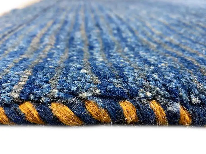 Close-up: blue carpet with yellow accents, dense textured pile
