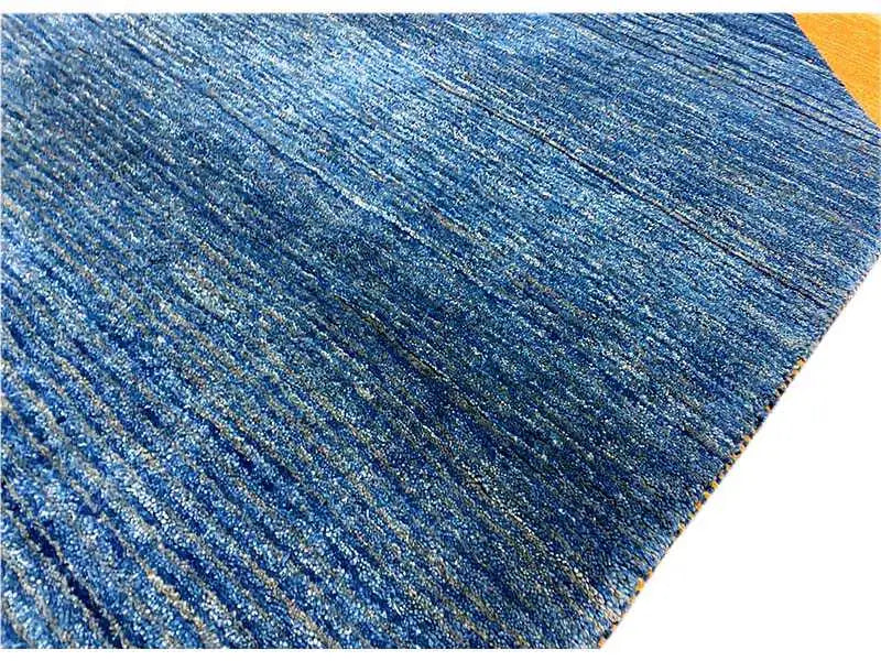 Blue Gabbeh rug, fine mottled lines in the pile, yellow accent zone