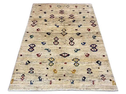 Gabbeh rug 164x116 cm in light beige with colorful decorative motifs and diamonds