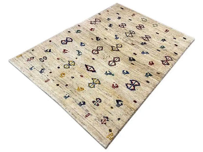 Gabbeh rug 164x116 cm, beige background with colorful diamond and animal motifs, angled
