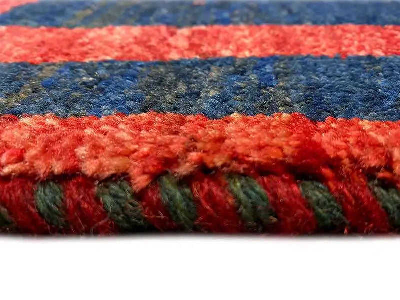 Gabbeh rug fringe: red and dark blue border with dense wool yarn