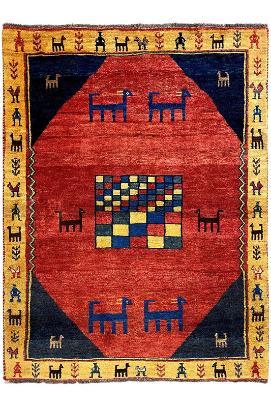 Gabbeh rug with a red diamond pattern, blue background, yellow border, and fringe