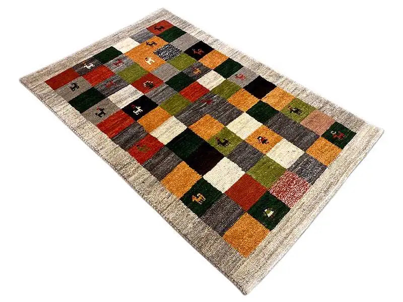 Gabbeh rug (149x96 cm), diagonal view: patchwork of colorful squares with animal motifs
