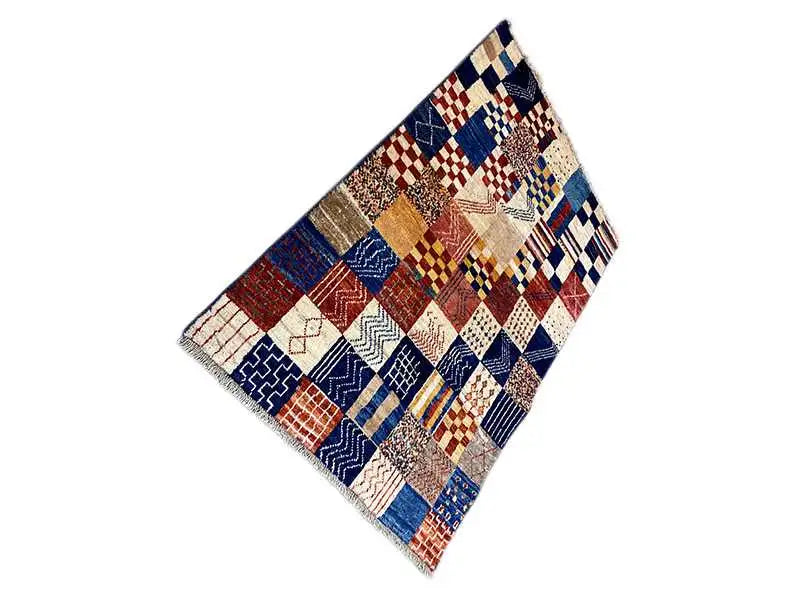 Gabbeh rug in a patchwork design, diagonal view, blue-red-cream-colored squares