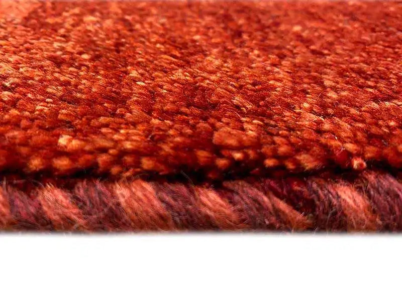 Gabbeh rug, detail of the densely woven reddish-brown pile surface