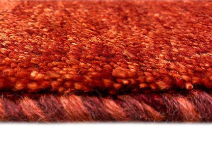 Gabbeh rug, detail of the densely woven reddish-brown pile surface