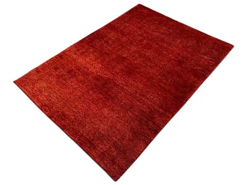 Gabbeh rug in reddish brown, rectangular, low pile with an even weave texture