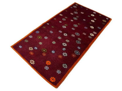 Carpet with dark red floral pattern and orange trim, 170x87 cm