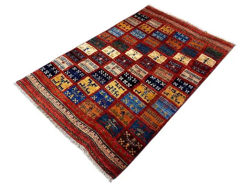 Gabbeh rug with patchwork diamonds in red, blue, yellow and black, rectangular, fringed