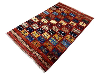 Gabbeh rug with patchwork diamonds in red, blue, yellow and black, rectangular, fringed