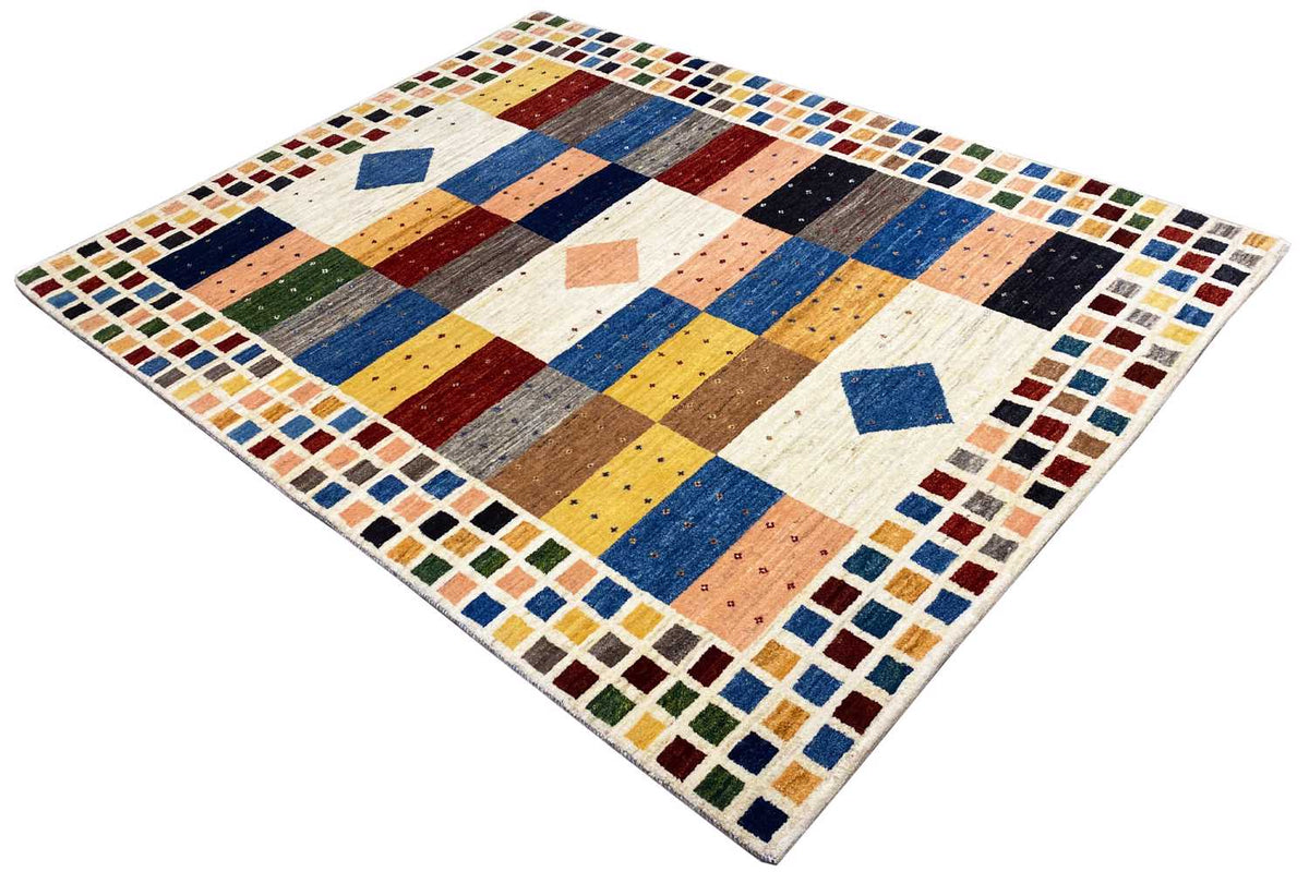 Gabbeh rug in oblique view with multicolored stripes, diamonds, and border tiles