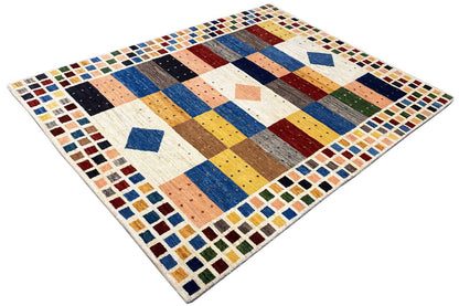 Gabbeh rug with diagonal color blocks in blue, yellow, brown, and cream