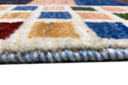 Gabbeh rug finish: fringe and woven border in blue, beige, and gray