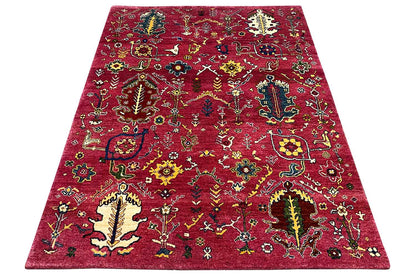 Red Gabbeh rug with a colorful pattern, spread at an angle