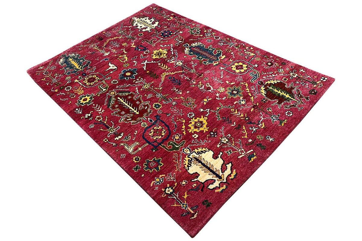 Red Gabbeh rug with a colorful design, diagonal view