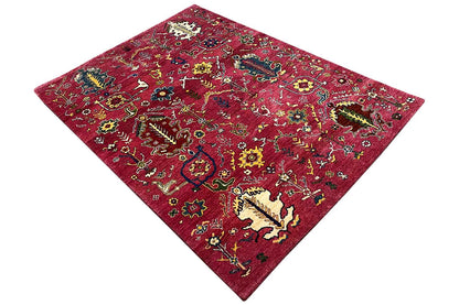 Red Gabbeh rug with a colorful design, diagonal view