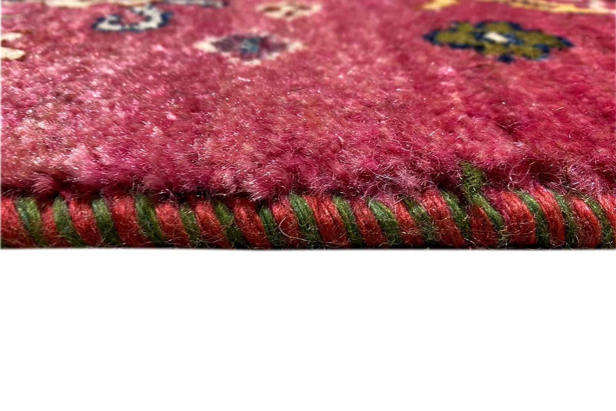 Red Gabbeh rug: fringed edge with colorful threads