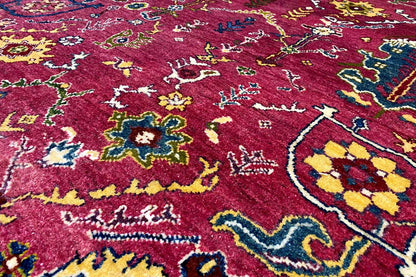 Red Gabbeh rug with a dense pile and colorful ornamental details