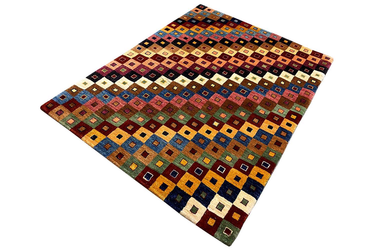 Gabbeh rug, diagonal view, geometric tile pattern in orange, blue, green, and beige