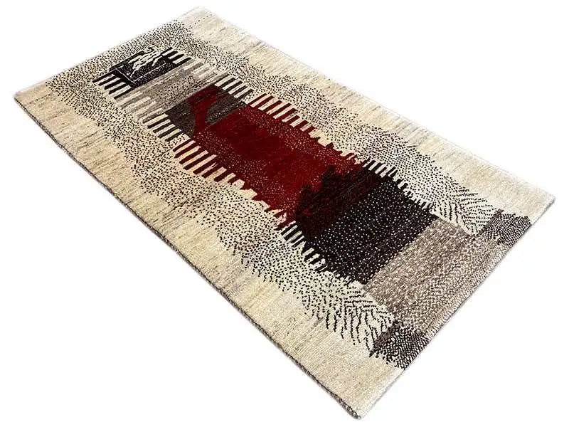 Gabbeh rug, beige base with a red and black geometric border, laid diagonally