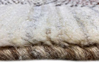 Close-up of Gabbeh rug: beige pile with a dense, dark border texture
