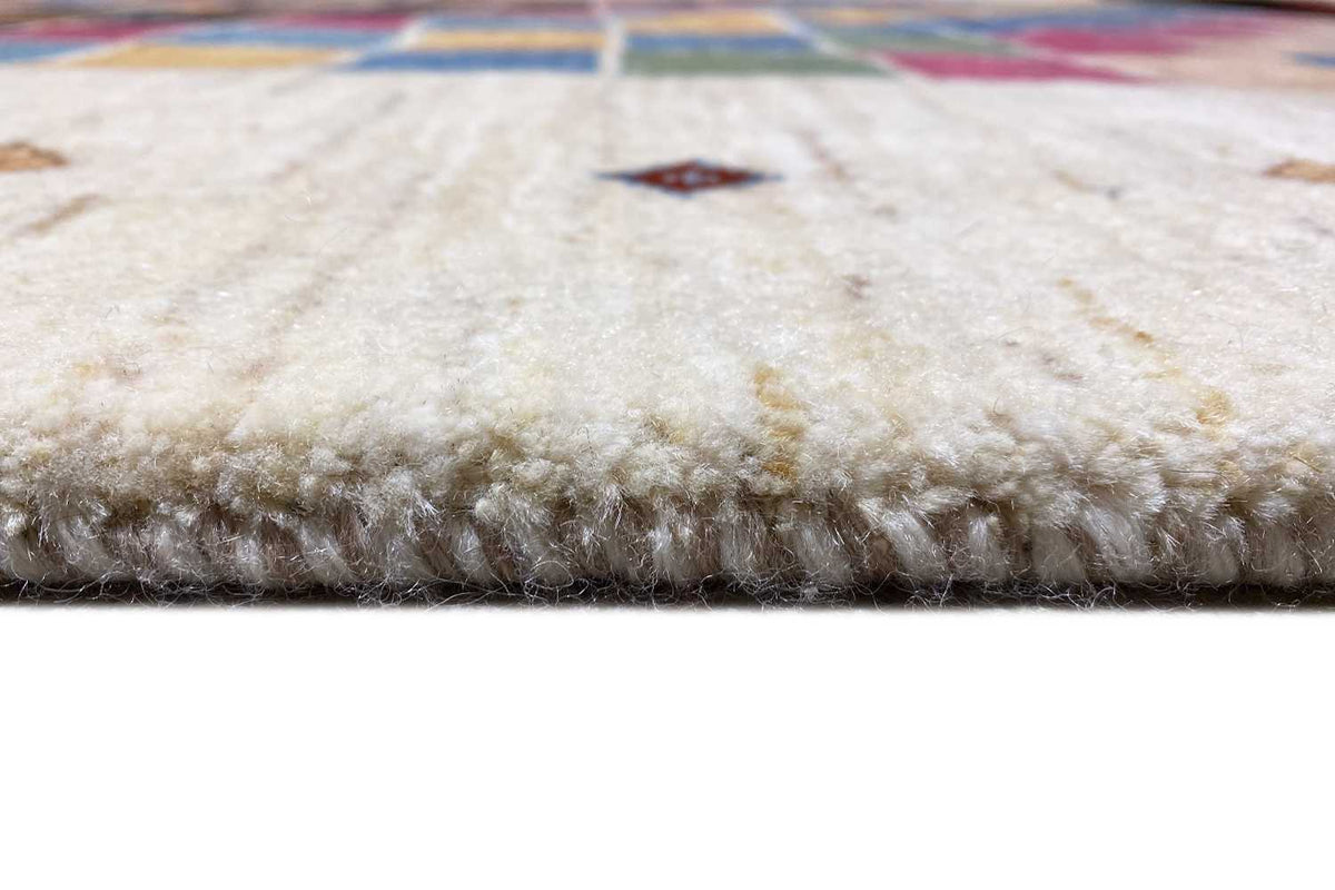 Carpet edge with dense pile and a multicolored border at the edge, on a light background