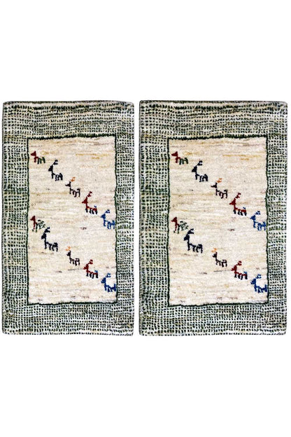 Gabbeh rug: beige pile with a gray-green border and multicolored animal motifs