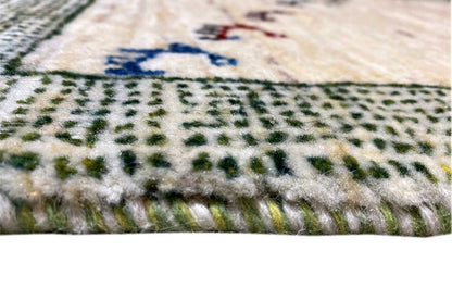 Close-up of carpet edge: dense pile, beige center, gray-green patterned border