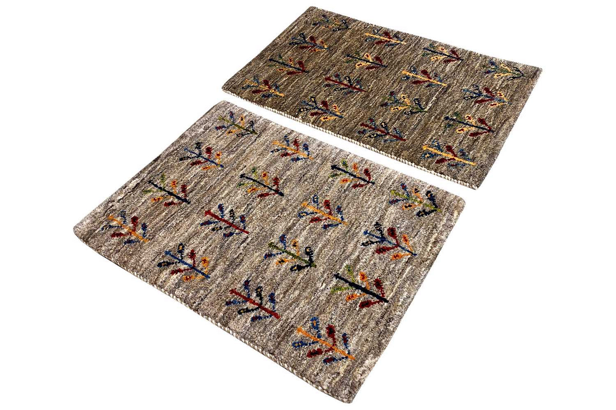 Gabbeh rug 40x60 cm, two pieces viewed from above at an angle with a colorful vine pattern